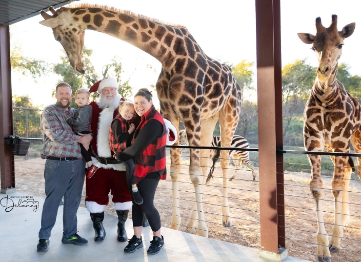 Santa at a giraffe farm with family